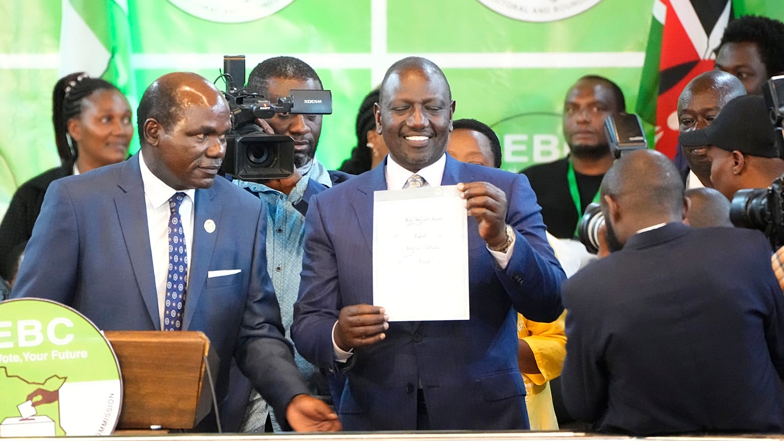 William Ruto, centre, shows a certificate after the announcement of the results of the presidential race at the Centre in Bomas, Nairobi, Kenya, Monday, Aug. 15, 2022.