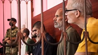 (L-R) Andrew Hill, Dylan Healy, Vjekoslav Prebeg, John Harding and Mathias Gustafsson in a courtroom in the unrecognized Donetsk People's Republic, August 15, 2022.