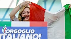 FILE — Giorgia Meloni holds an Italian flag as she addresses a rally in Rome, Saturday, Oct. 19, 2019. 