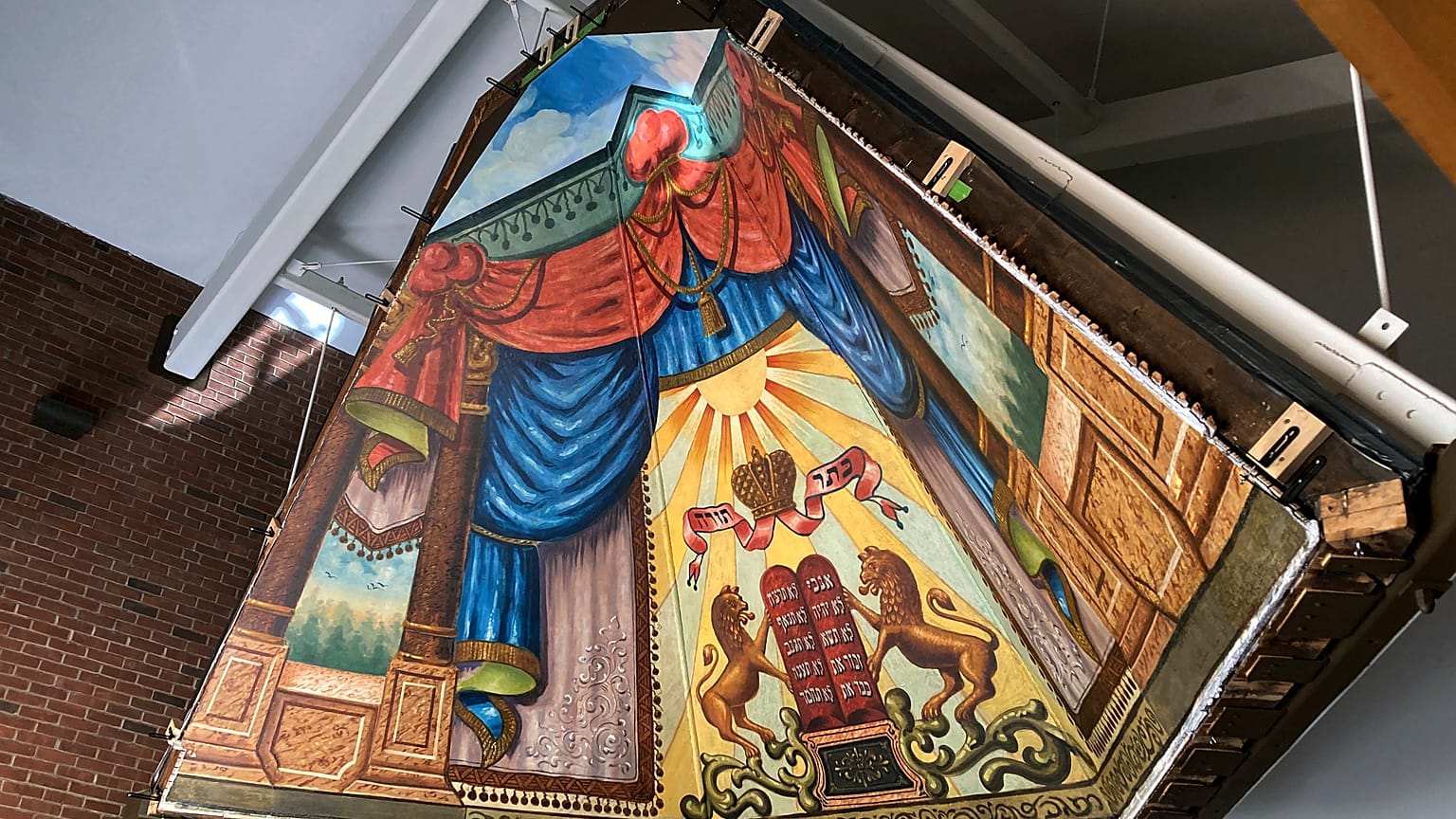 The mural painted in 1910 by a Lithuanian immigrant has been rehabilitated and moved and is what experts say is a rare piece of art.