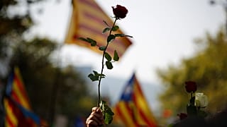 A rose is held aloft during a demonstration condemning the attacks in 2017.
