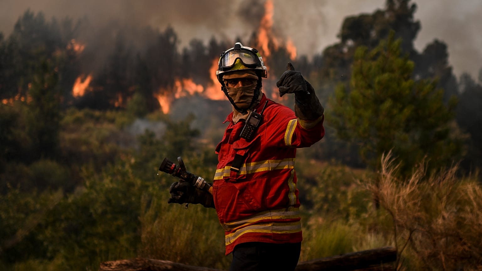 A firefighter works to combat a wildfire in Orjais, Covilha council in central Portugal, on August 16, 2022.