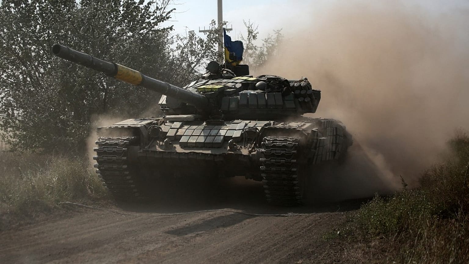A Ukrainian tank rolls down a road at a position along the front line in the Donetsk region on August 15, 2022.