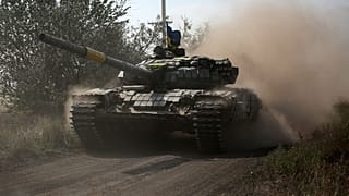 A Ukrainian tank rolls down a road at a position along the front line in the Donetsk region on August 15, 2022.