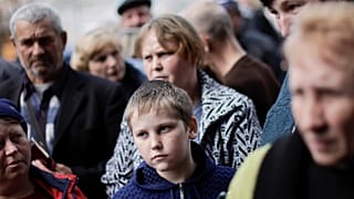 Ukrainian refugees wait to collect aid and register at a centre for internally displaced people, amid Russia's invasion of Ukraine, in the town of Kryvyi Rih