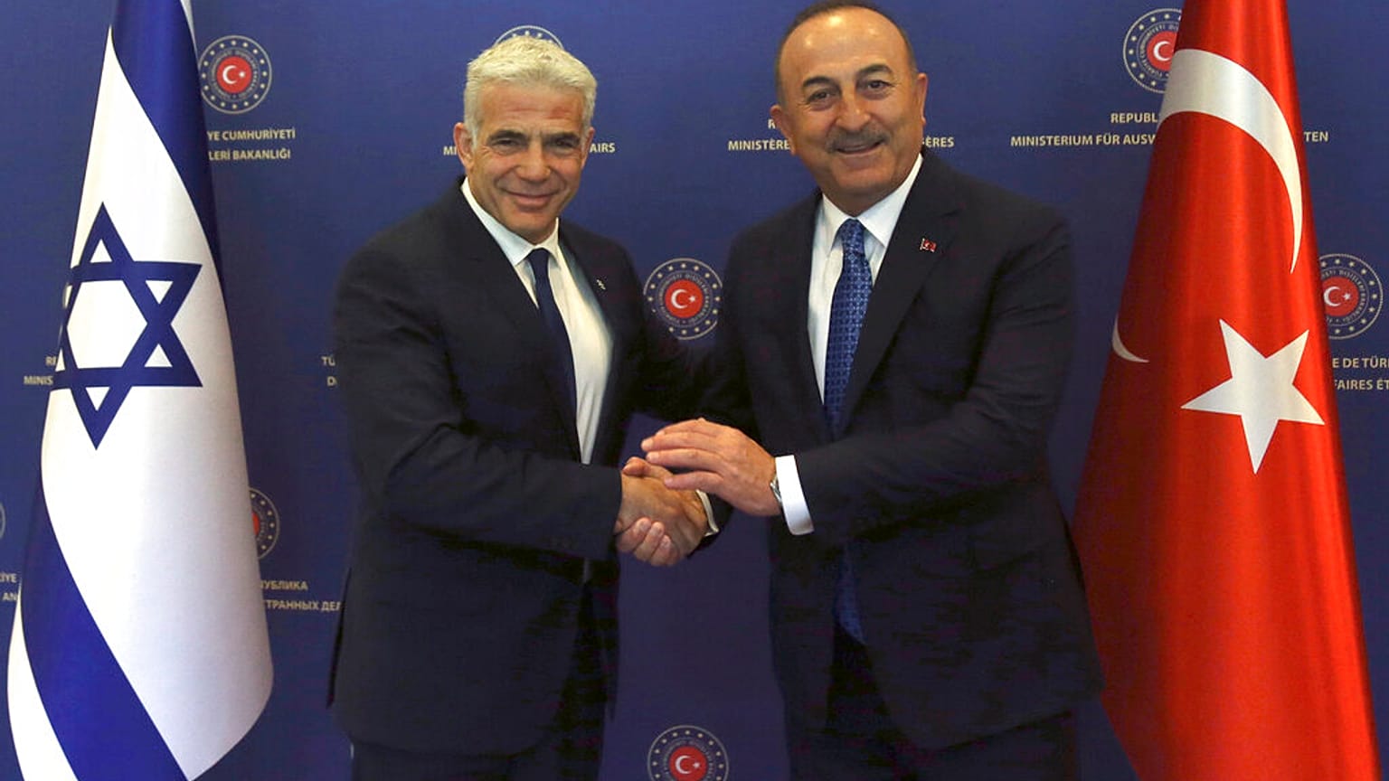 Turkish Foreign Minister Mevlut Cavusoglu, right, and Israeli Foreign Minister Yair Lapid pose for photos before their talks, in Ankara, Turkey, June 23, 2022.