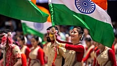 Assamese girls and boys in traditional attire carry Indian flags as they perform Bihu dance on Independence Day in Gauhati, northeastern Assam state, India, Aug. 15, 2022
