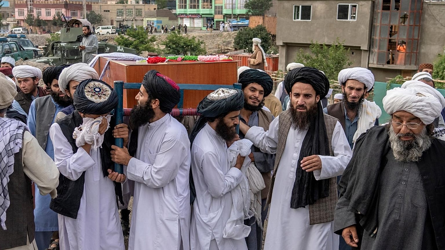 Mourners carry the body of a victim of a mosque bombing in Kabul, Afghanistan, Thursday, Aug. 18. 2022.
