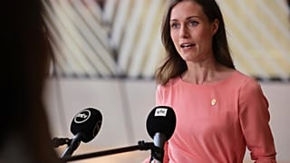 Finland's Prime Minister Sanna Marin speaks with the media as she arrives for an EU summit in Brussels, Thursday, June 23, 2022.