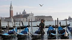 A tourist takes a selfie in St. Mark's Square in Venice, Italy. 