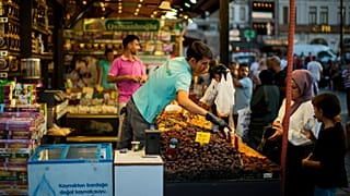 A clerk talks to a customer at the Egyptian spices market in Istanbul, 18 August 2022