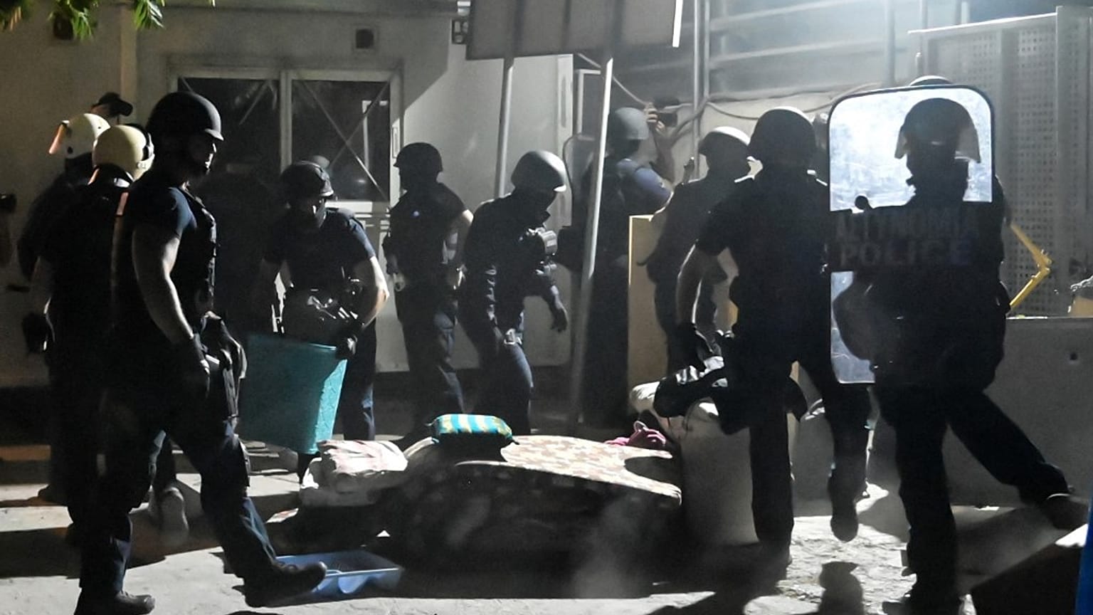 Greek riot police removed some barricaddes before a raid on Eleonas camp near Athens.