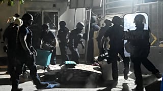 Greek riot police removed some barricaddes before a raid on Eleonas camp near Athens.