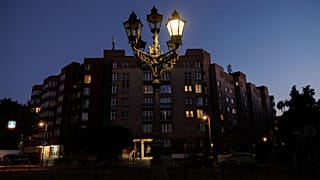 A partly glowing gas street lamp is seen at dusk in Berlin, Germany, August 11 2022.
