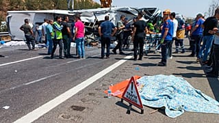 Images from the scene of one accident show an ambulance with severe rear damage and an overturned bus.