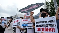 Protesters stage a rally to oppose the joint military exercises between the U.S. and South Korea in front of the presidential office in Seoul, South Korea, Aug. 22, 2022.