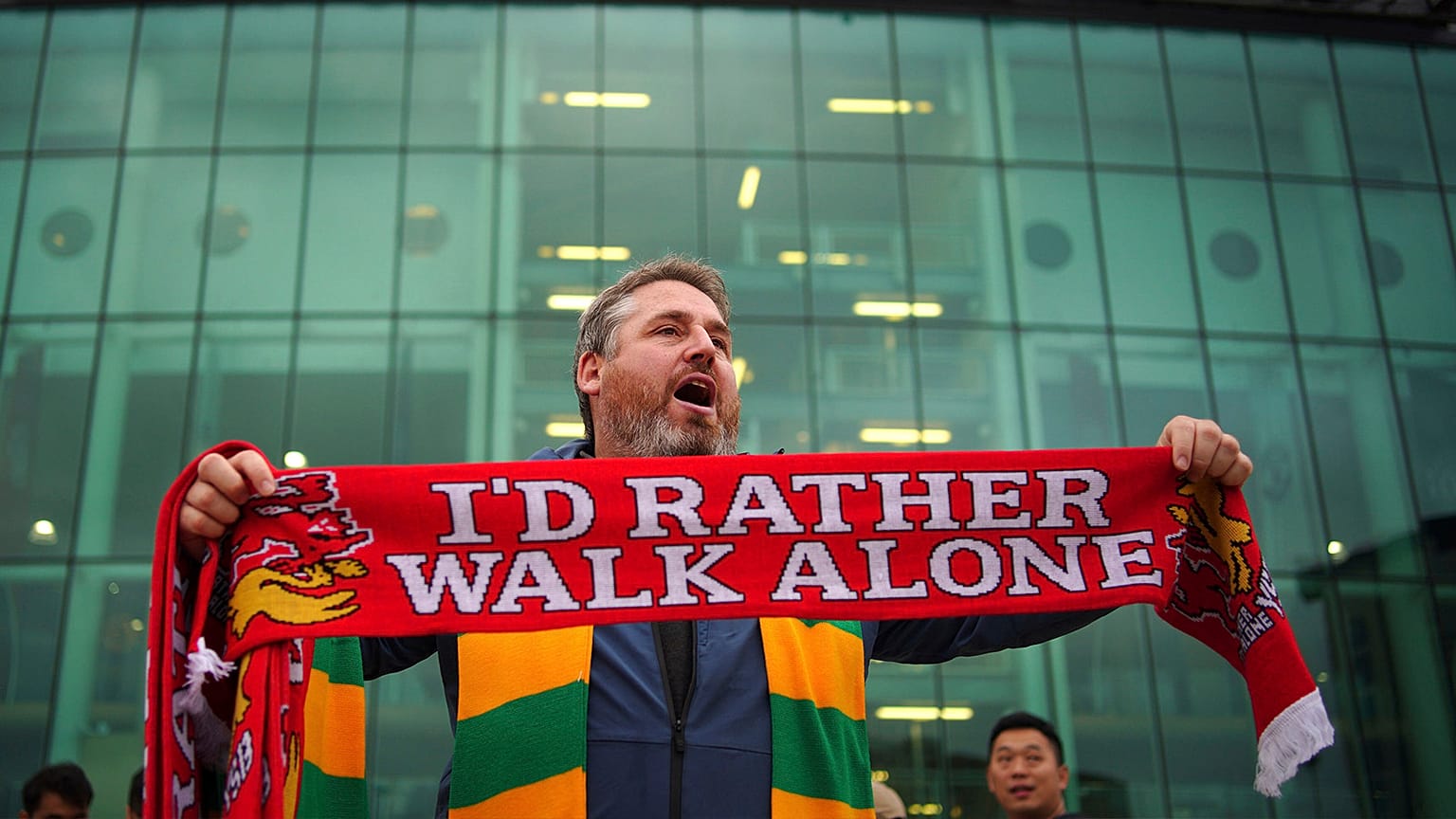A man sells scarves outside the Old Trafford ground, Manchester, 22 August 2022
