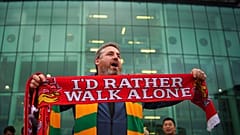 A man sells scarves outside the Old Trafford ground, Manchester, 22 August 2022
