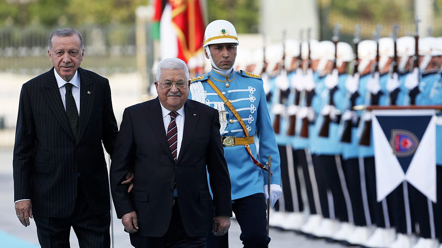 Turkey's President Recep Tayyip Erdogan and Palestinian President Mahmoud Abbas review a military honour guard during a welcome ceremony in Ankara, 23 August 2022