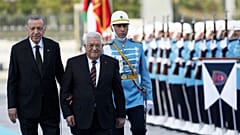 Turkey's President Recep Tayyip Erdogan and Palestinian President Mahmoud Abbas review a military honour guard during a welcome ceremony in Ankara, 23 August 2022