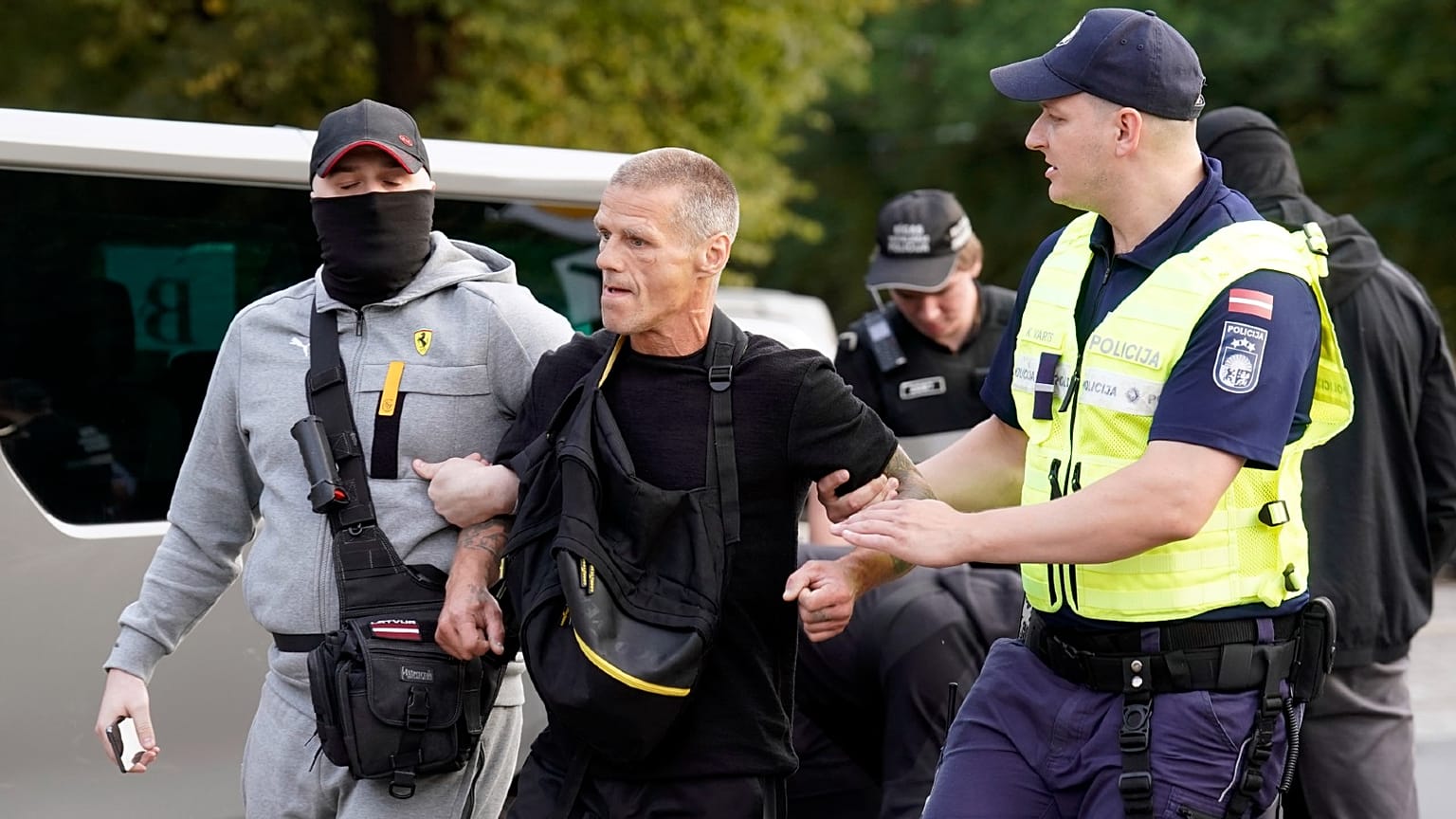 Police officers detain an activist protesting against the demolition of The Monument to the Liberators of Soviet Latvia and Riga from the German Fascist Invaders, in Riga