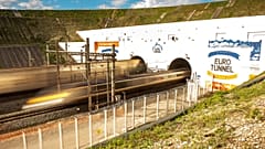 This photo taken on October 20, 2015 in Coquelles shows Eurotunnel train and shuttle entering the Eurotunnel, during the inauguration of a new Eurotunnel freight line.