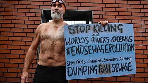 English Channel swimmer Peter Green protests against the dumping of raw sewage into the sea, in Glasgow on November 12, 2021, during the COP26 UN Climate Change Conference.