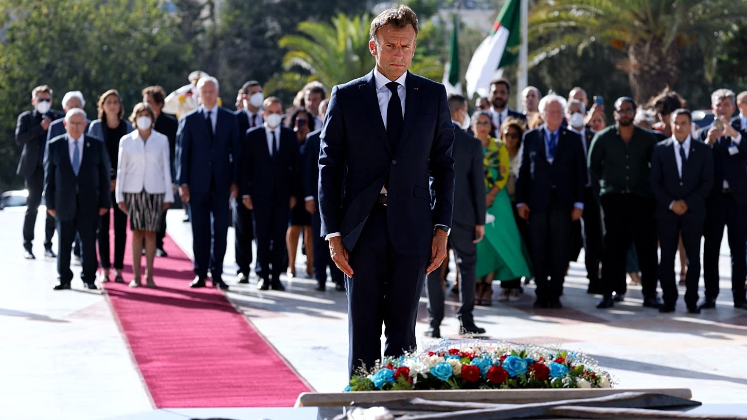 French President Emmanuel Macron pays his respect after laying a floral wreath at the Martyrs Monument in Algiers on August 25, 2022.