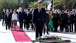 French President Emmanuel Macron pays his respect after laying a floral wreath at the Martyrs Monument in Algiers on August 25, 2022.