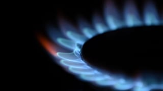 In this file photo illustration taken on February 2, 2022, gas is seen burning on a domestic hob in Brighton, southern England.