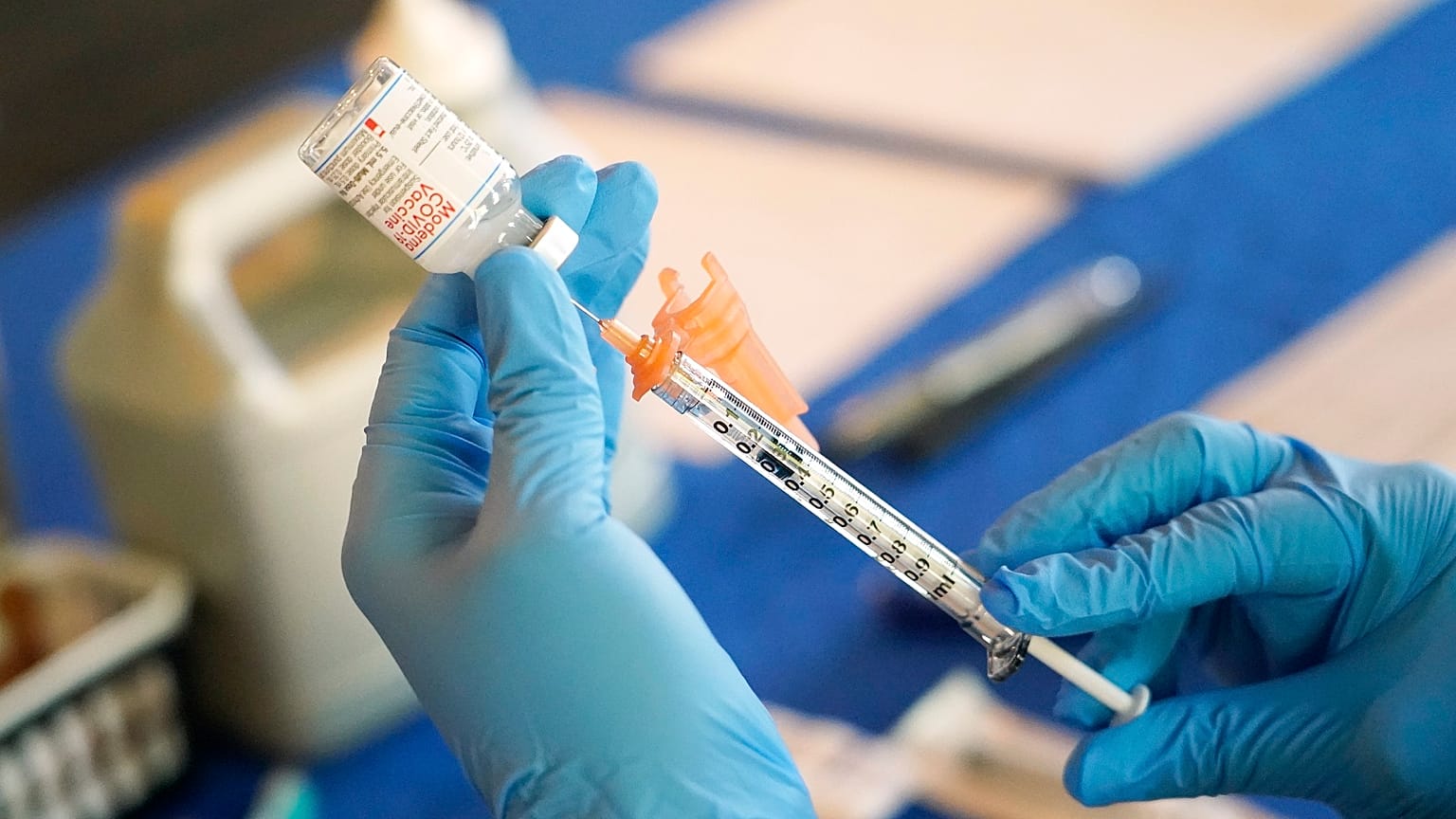A patient is administered with a dose of the Moderna COVID-19 vaccine.