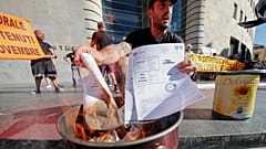 Protesters in Naples burn gas and electricity bills as part of a demonstration against soaring energy prices