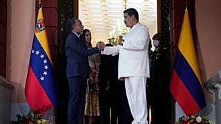 El presidente de Venezuela, Nicolás Maduro (derecha), estrecha la mano del nuevo embajador de Colombia, Armando Benedetti, tras una reunión en el Palacio de Miraflores