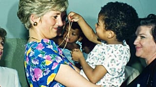 FILE - Britain's Princess Diana, the Princess of Wales, hugs and plays with an HIV positive baby in Faban Hostel, San Paulo, on April 24, 1991