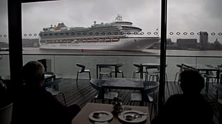 An Italian cruise ship is pictured leaving the port of Amsterdam in the Netherlands.