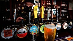 A barman draughts beer in the Black Lion pub in Hammersmith in London