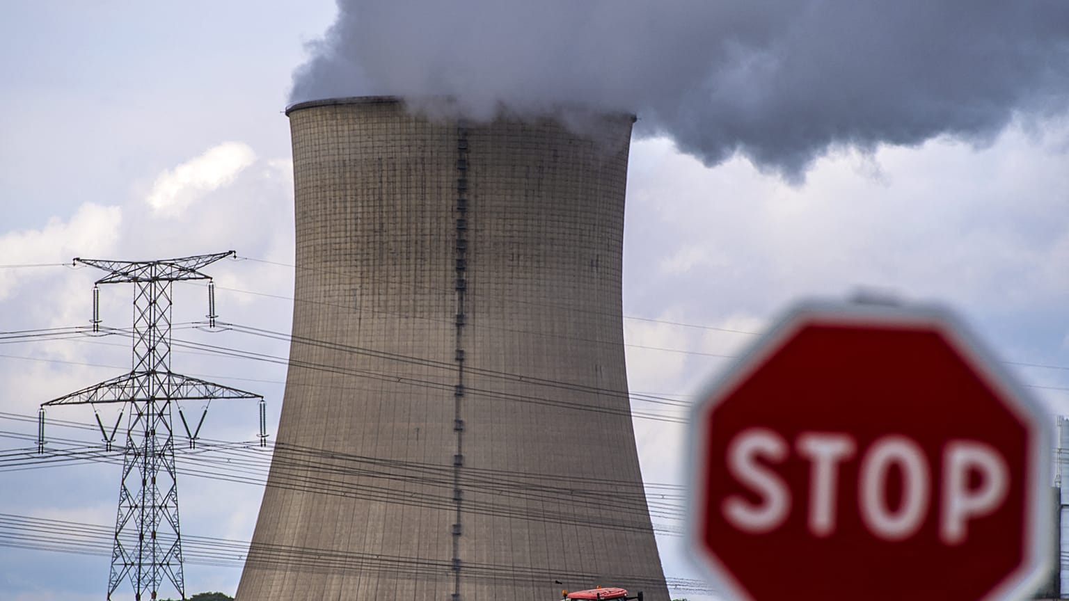 In this file photo taken on October 12, 2017, a farmer drives his tractor in front of the nuclear power plant in Cattenom, eastern France