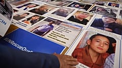 FILE: Members of Muslim Uyghur minority present pictures of their relatives detained in China during a press conference in Istanbul, on May 10, 2022. 
