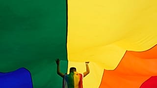A participant holds up a large rainbow flag during the annual LGBT pride march in Belgrade, 18 September 2021