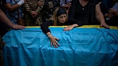 Anastasia Ohrimenko, 26, cries over her husband's coffin Yury Styglyuk, a Ukrainian serviceman who died in combat on August 24 in Maryinka, Donetsk, during his funeral.