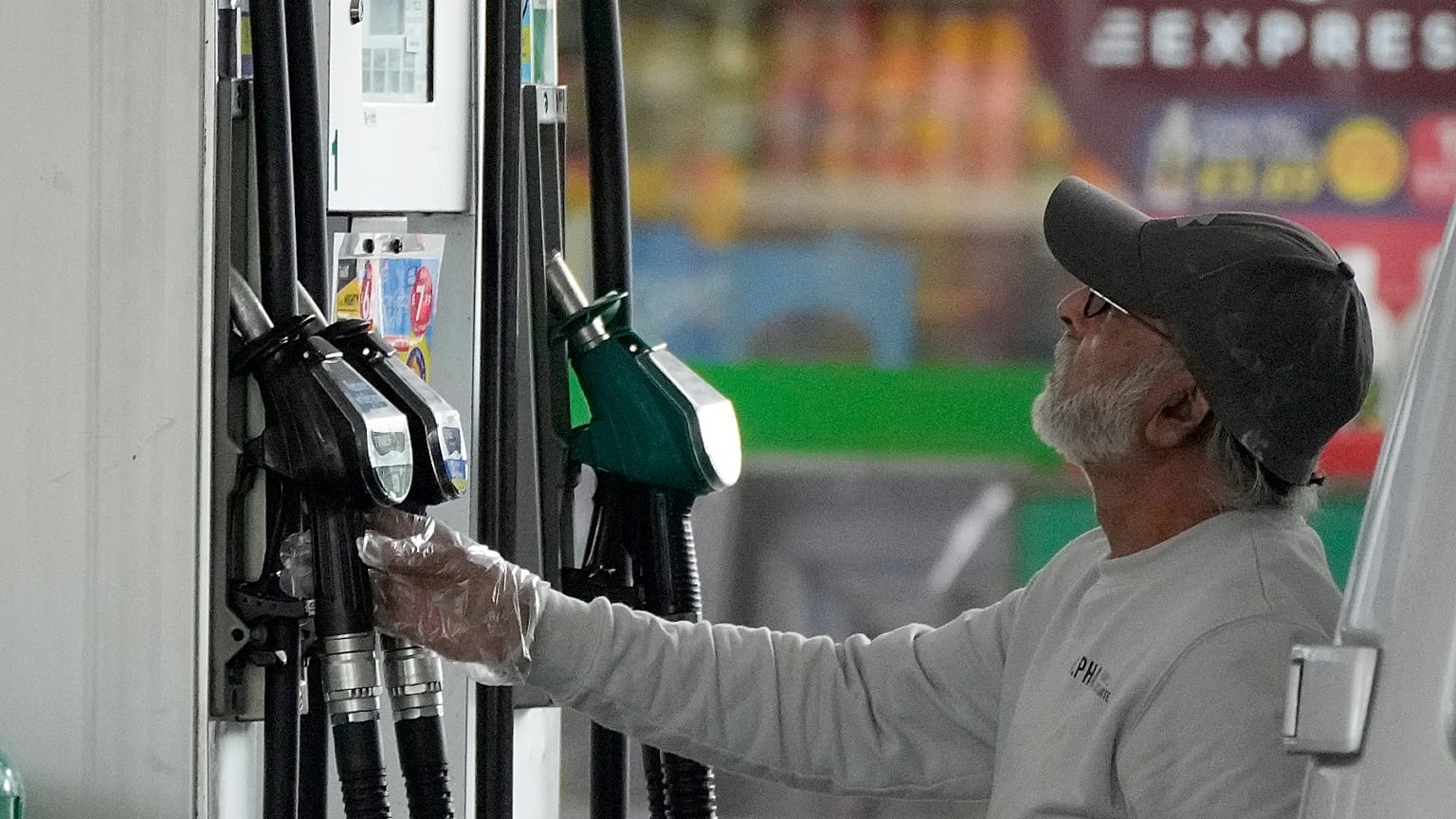 FILE - A driver looks at the petrol pump at a petrol station in London, Thursday, June 9, 2022. 