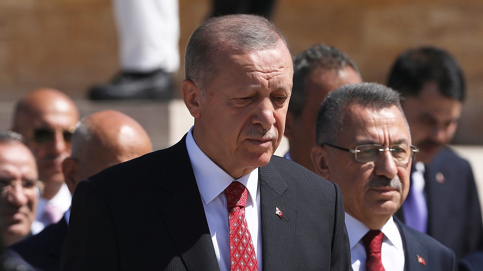 Recep Tayyip Erdogan and other officials walk to the mausoleum of modern Turkey's founder Mustafa Kemal Ataturk on Victory Day, 30 August 2022