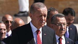 Recep Tayyip Erdogan and other officials walk to the mausoleum of modern Turkey's founder Mustafa Kemal Ataturk on Victory Day, 30 August 2022
