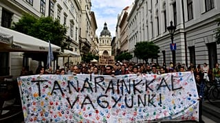 Students hold a banner reading "we stand by our teacher" during a protest in solidarity with their teachers in Budapest.