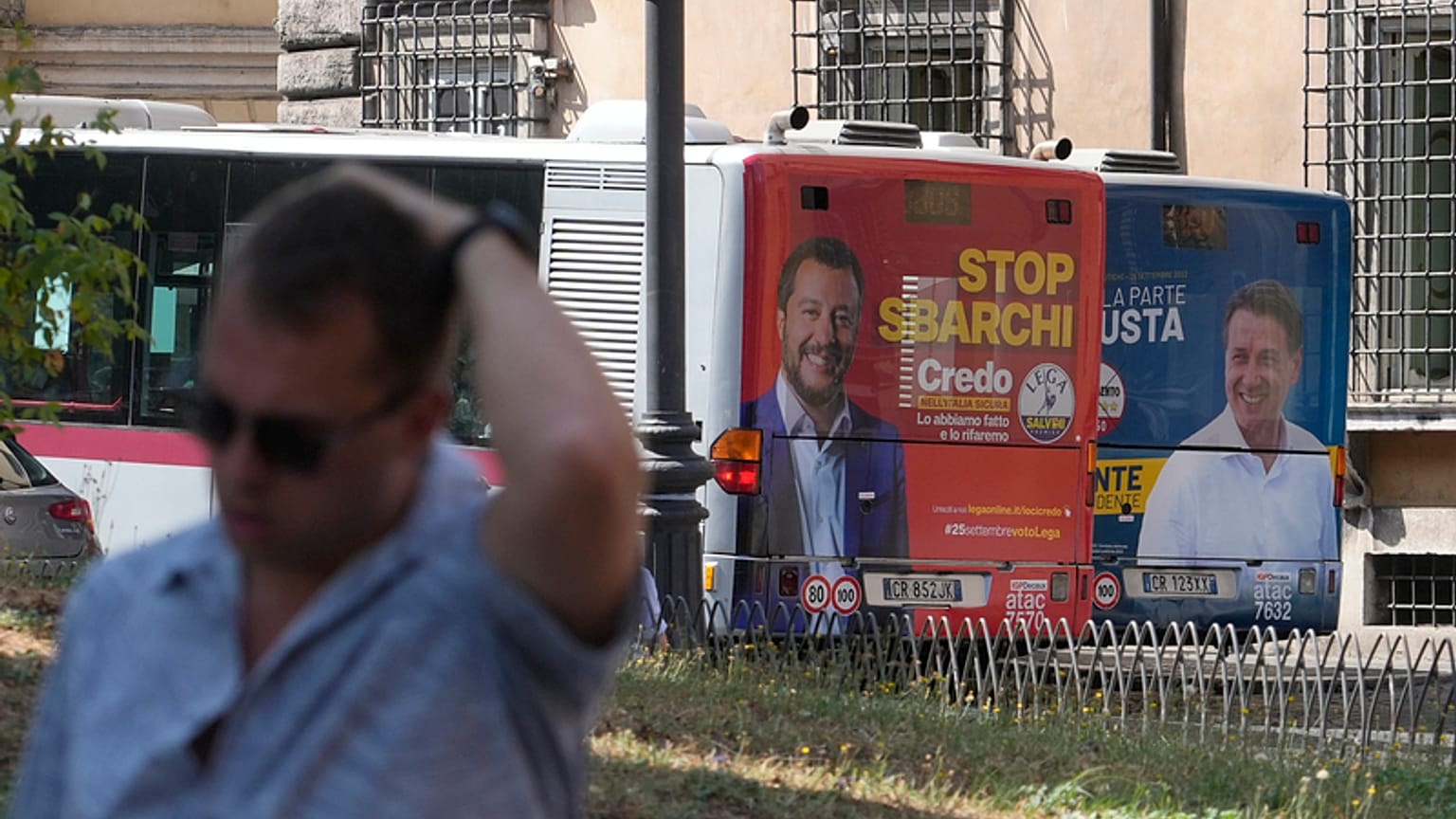 The electoral posters of the Northern League (left) and the Five Star Movement (right) on buses in Rome, Italy, on 1 September 2022.