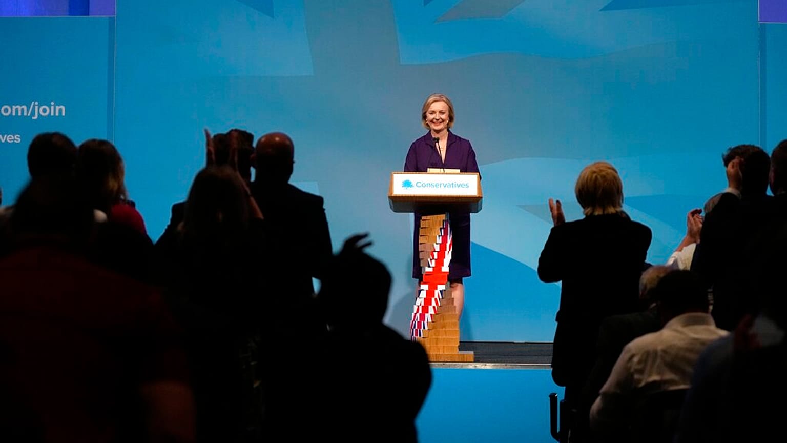 People applaud British lawmaker Liz Truss after winning the Conservative Party leadership contest
