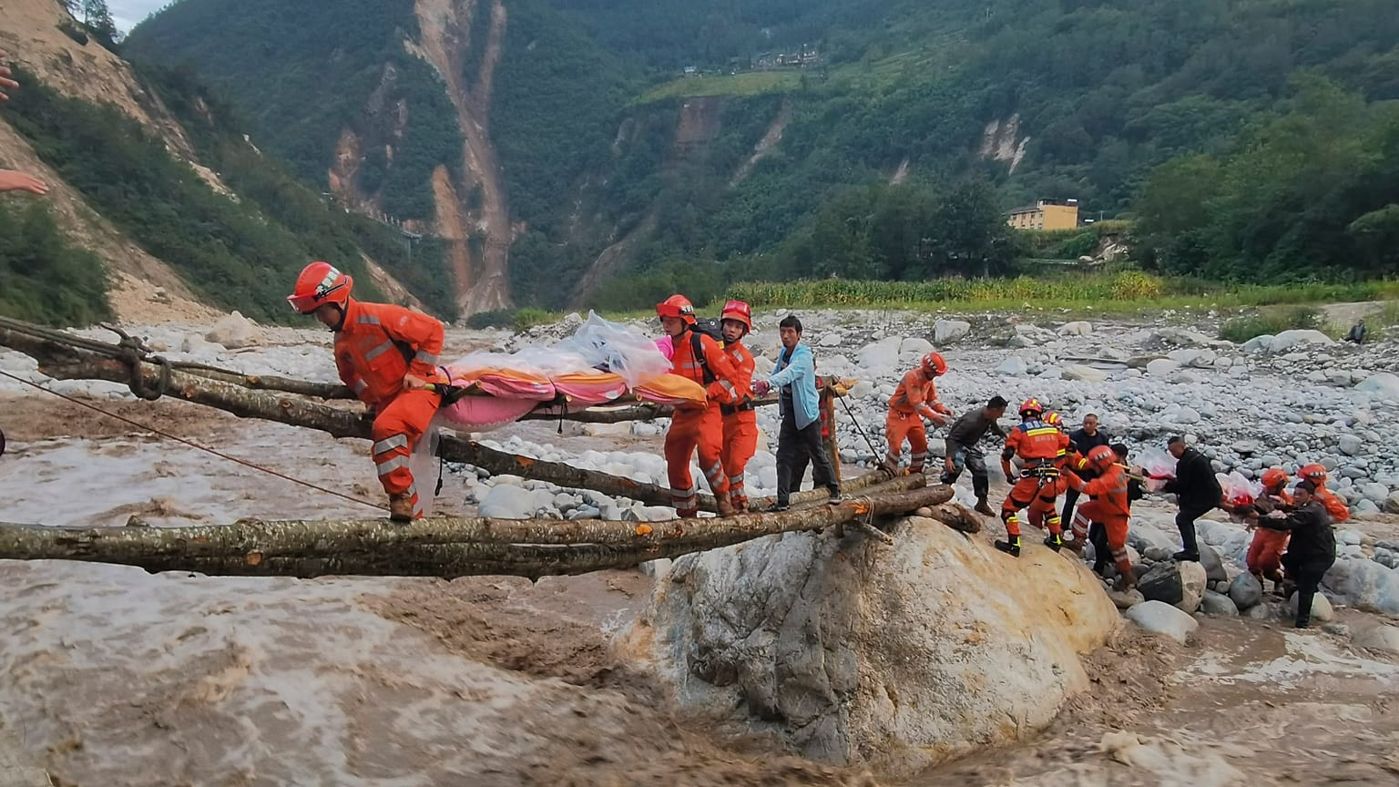 Rescuers transfer survivors across a river in Sichuan Province following the earthquake.