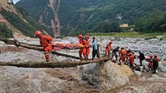 Rescuers transfer survivors across a river in Sichuan Province following the earthquake.