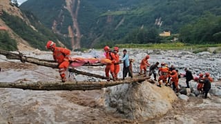 Rescuers transfer survivors across a river in Sichuan Province following the earthquake.