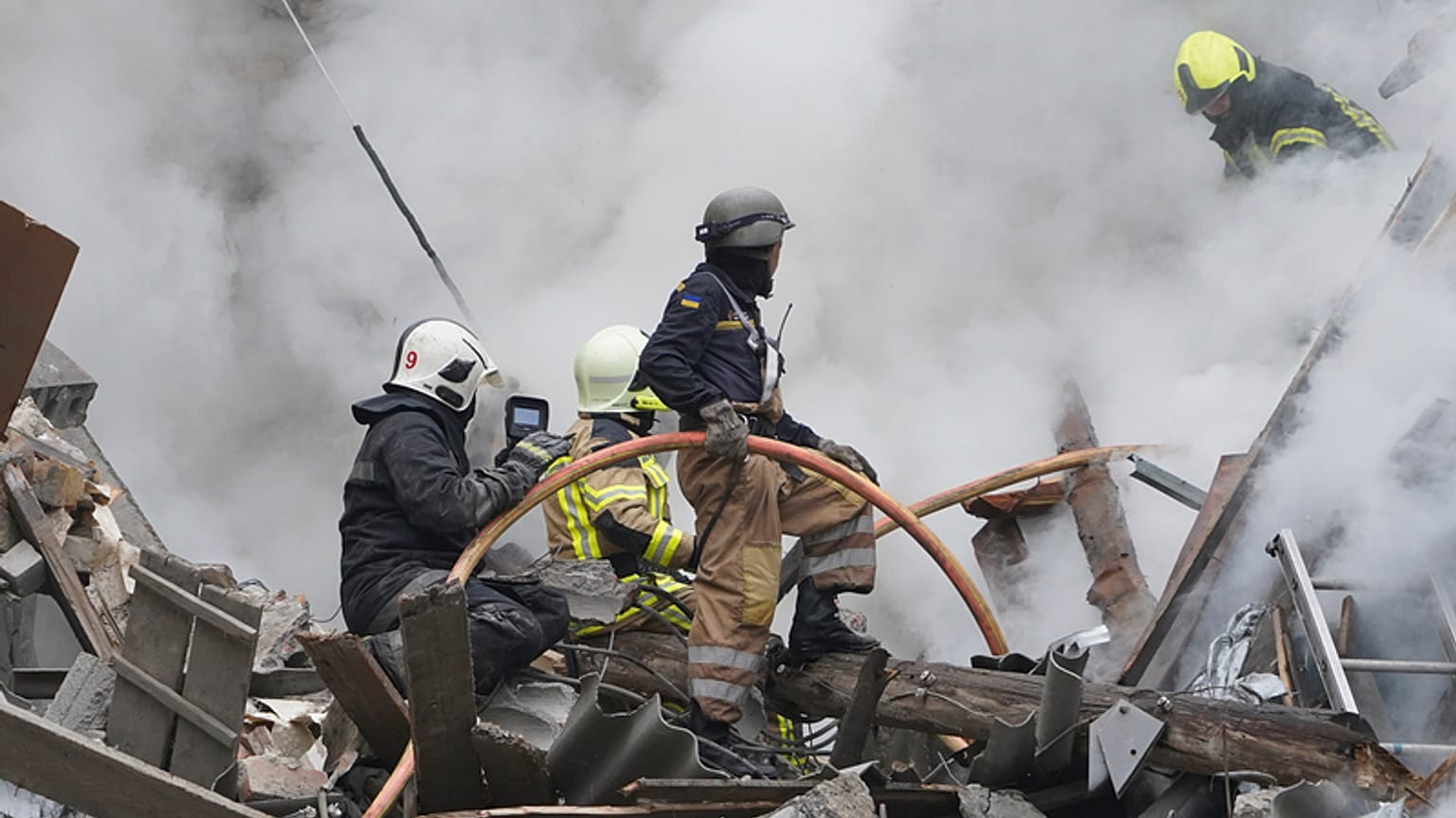 Ukrainian firefighters work among debris from destroyed buildings after the latest Russian rocket attack in center Kharkiv, Ukraine, Tuesday, 6 September, 2022.